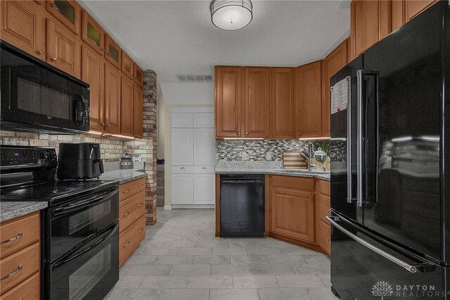 1395 Chickasaw Dr, London, OH 43140 - kitchen featuring black appliances, tasteful backsplash, and brown cabinets