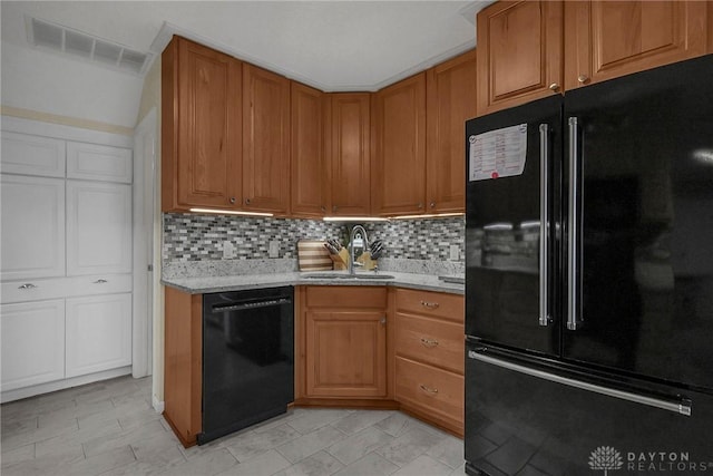 1395 Chickasaw Dr, London, OH 43140 - kitchen featuring black appliances, a sink, backsplash, and brown cabinetry