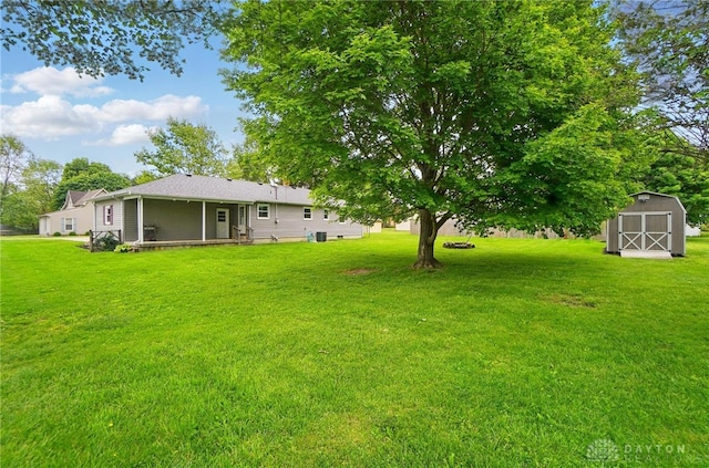 56 W Xenia St, Jamestown Vlg, OH 45335 - view of grassy yard featuring a storage unit and an outbuilding