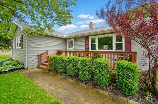 56 W Xenia St, Jamestown Vlg, OH 45335 - view of front facade with a chimney and a deck