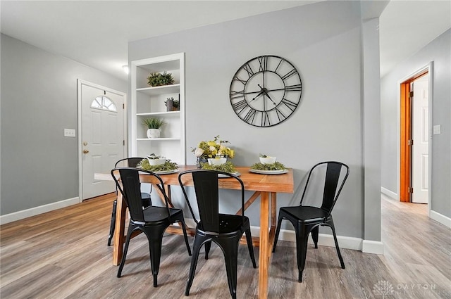 56 W Xenia St, Jamestown Vlg, OH 45335 - dining room featuring light wood-type flooring, baseboards, and built in features