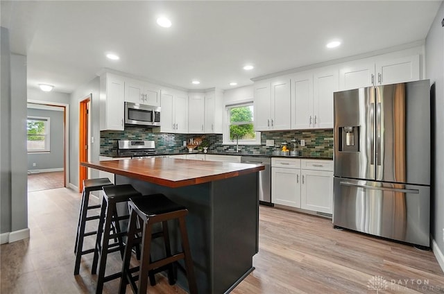 56 W Xenia St, Jamestown Vlg, OH 45335 - kitchen featuring stainless steel appliances, wooden counters, tasteful backsplash, baseboards, and a sink