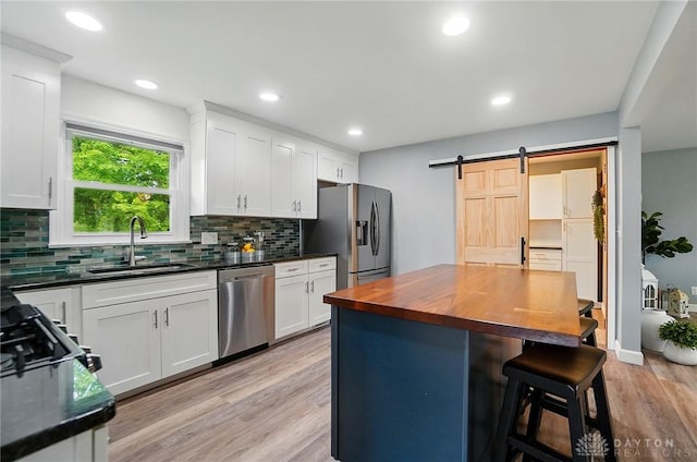 56 W Xenia St, Jamestown Vlg, OH 45335 - kitchen with stainless steel appliances, a sink, wooden counters, tasteful backsplash, and a kitchen bar