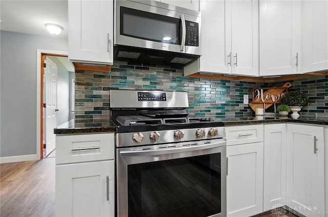 56 W Xenia St, Jamestown Vlg, OH 45335 - kitchen featuring stainless steel appliances, tasteful backsplash, white cabinetry, and dark stone countertops