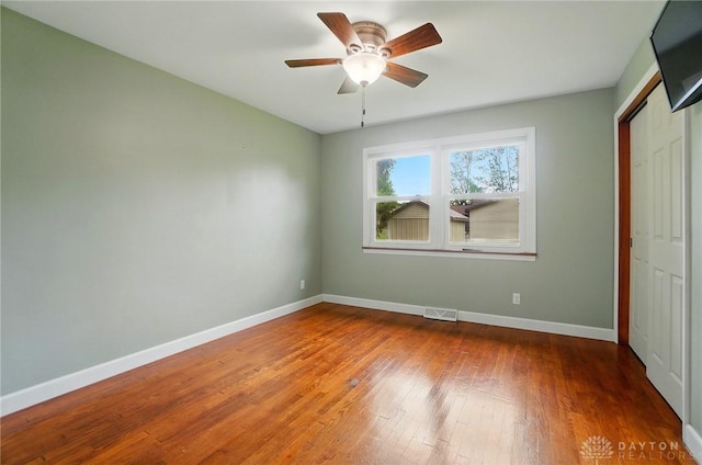 56 W Xenia St, Jamestown Vlg, OH 45335 - unfurnished bedroom featuring baseboards, hardwood / wood-style flooring, a closet, and ceiling fan