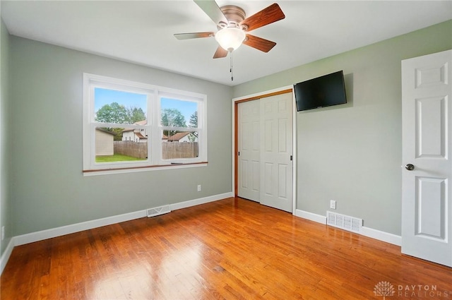 56 W Xenia St, Jamestown Vlg, OH 45335 - unfurnished bedroom with baseboards, wood finished floors, a closet, and ceiling fan