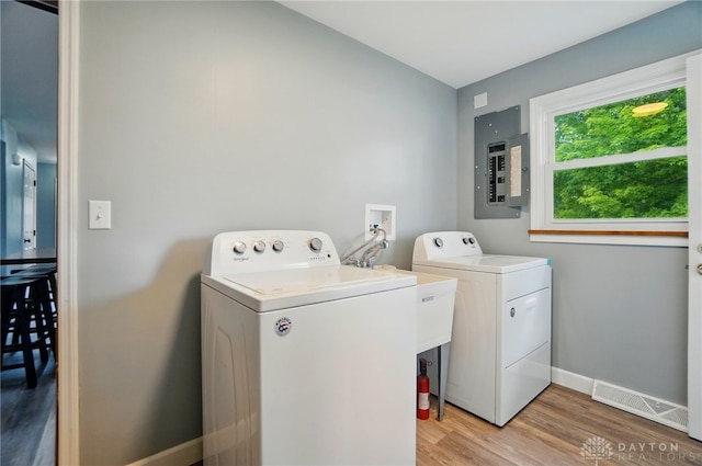 56 W Xenia St, Jamestown Vlg, OH 45335 - washroom featuring electric panel, independent washer and dryer, light wood-style flooring, and baseboards