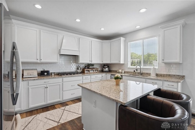 4061 Woodland Ridge Ct, Bellbrook, OH 45440 - kitchen with a sink, premium range hood, appliances with stainless steel finishes, dark wood-type flooring, and white cabinetry