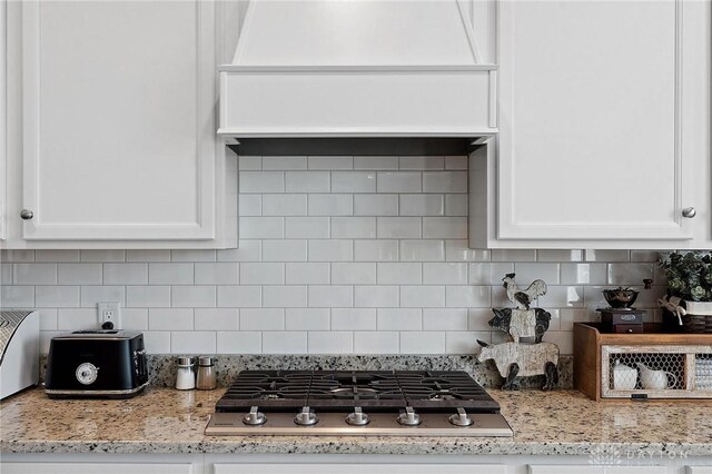 4061 Woodland Ridge Ct, Bellbrook, OH 45440 - kitchen featuring stainless steel gas stovetop, white cabinetry, and light stone countertops