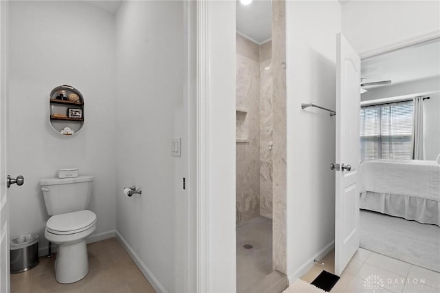 4061 Woodland Ridge Ct, Bellbrook, OH 45440 - full bathroom with a tile shower, tile patterned flooring, toilet, baseboards, and ensuite bathroom