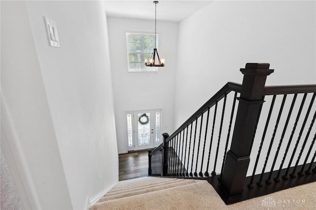 4061 Woodland Ridge Ct, Bellbrook, OH 45440 - staircase with a chandelier, healthy amount of natural light, and carpet flooring