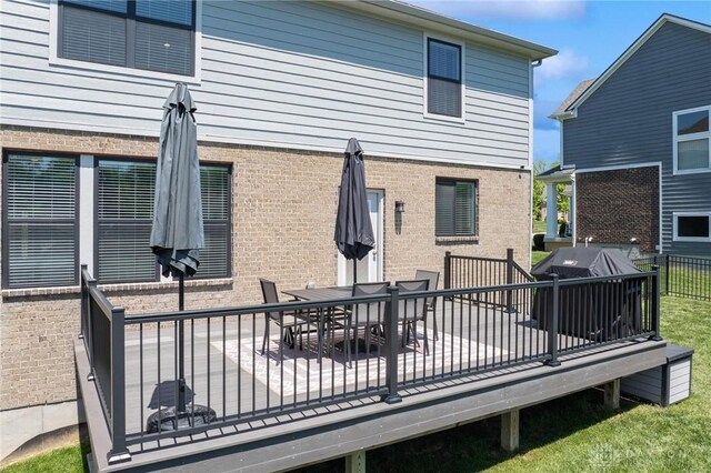 4061 Woodland Ridge Ct, Bellbrook, OH 45440 - rear view of property with brick siding, outdoor dining area, and a wooden deck