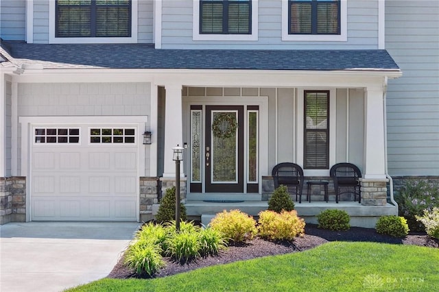4061 Woodland Ridge Ct, Bellbrook, OH 45440 - view of exterior entry featuring covered porch, stone siding, roof with shingles, and driveway