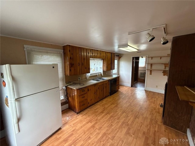 318 E Main St, Bradford, OH 45308 - kitchen featuring freestanding refrigerator, brown cabinetry, dishwasher, light countertops, and light wood-style flooring