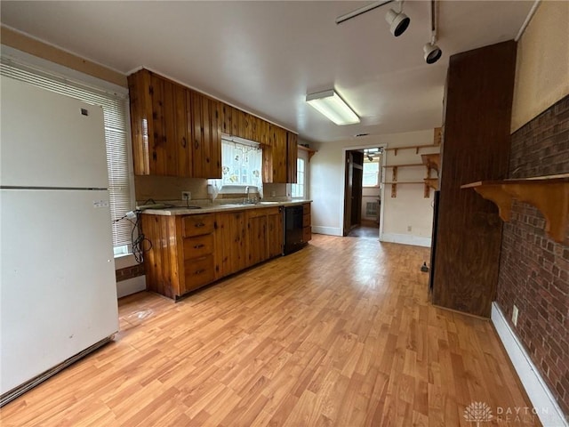 318 E Main St, Bradford, OH 45308 - kitchen with freestanding refrigerator, black dishwasher, brown cabinets, light wood-type flooring, and light countertops