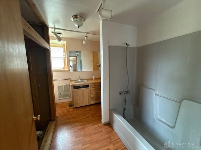 318 E Main St, Bradford, OH 45308 - full bathroom with rail lighting, wood finished floors, shower / bath combination, and vanity
