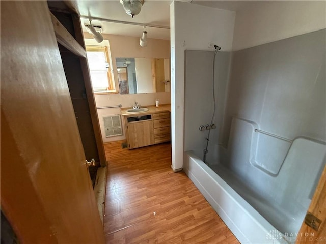 318 E Main St, Bradford, OH 45308 - full bathroom featuring wood finished floors, washtub / shower combination, and vanity