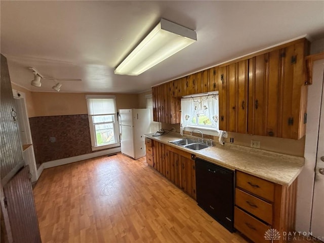 318 E Main St, Bradford, OH 45308 - kitchen with black dishwasher, a sink, brown cabinetry, freestanding refrigerator, and plenty of natural light