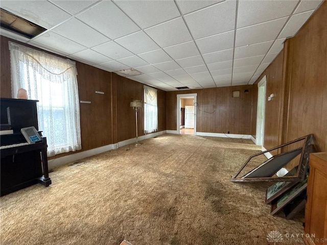 318 E Main St, Bradford, OH 45308 - unfurnished living room with carpet flooring, wood walls, and a drop ceiling