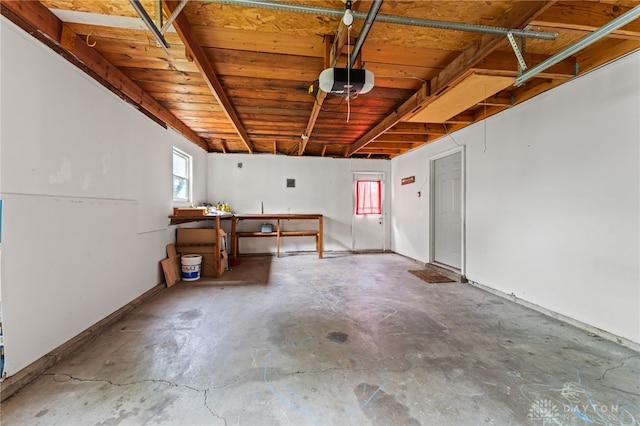 garage featuring a garage door opener and wood ceiling