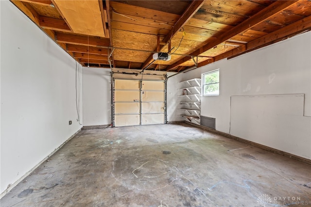 garage featuring a garage door opener and wood ceiling