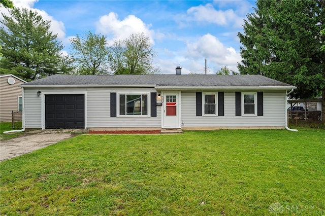 ranch-style home featuring an attached garage, asphalt driveway, and a front yard