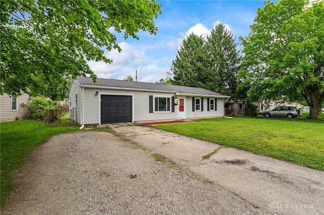 ranch-style home with a garage, driveway, and a front yard