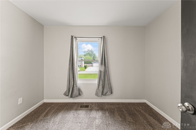 unfurnished room with carpet and baseboards