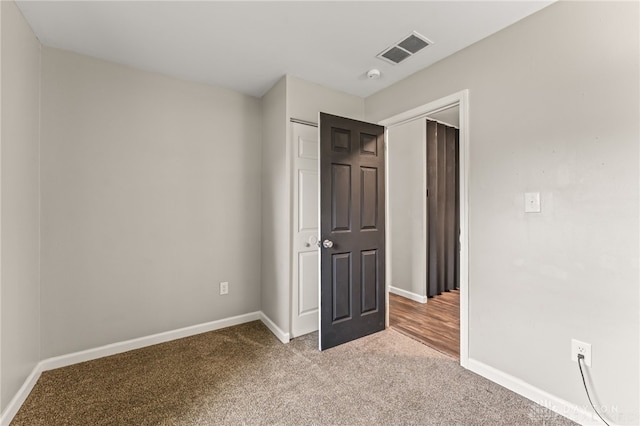 unfurnished bedroom with light carpet and baseboards