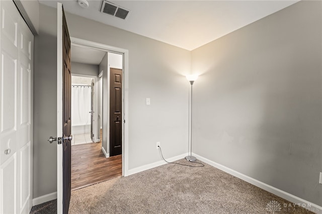 unfurnished bedroom featuring carpet and baseboards