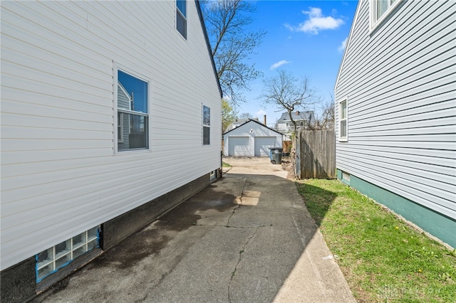 235 N Delmar Ave, Dayton, OH 45403 - view of home's exterior featuring a detached garage, concrete driveway, and an outdoor structure