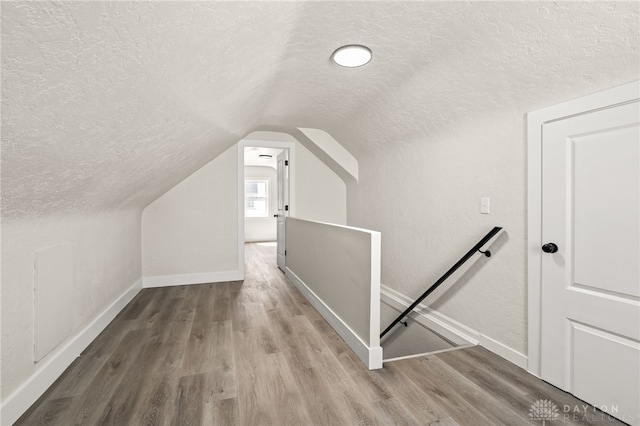 235 N Delmar Ave, Dayton, OH 45403 - bonus room featuring a textured ceiling, vaulted ceiling, wood finished floors, and baseboards