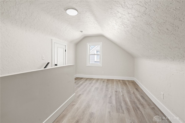 235 N Delmar Ave, Dayton, OH 45403 - bonus room featuring a textured ceiling, light wood-style flooring, lofted ceiling, a textured wall, and baseboards