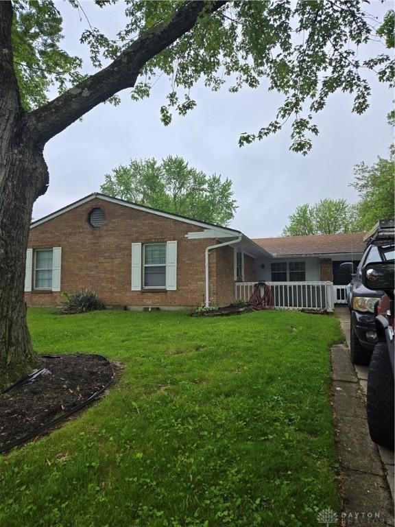 4549 Sylvan Oak Dr, Dayton, OH 45426 - view of home's exterior with brick siding and a lawn