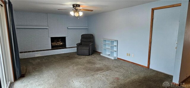 unfurnished living room featuring carpet flooring, a ceiling fan, and a brick fireplace
