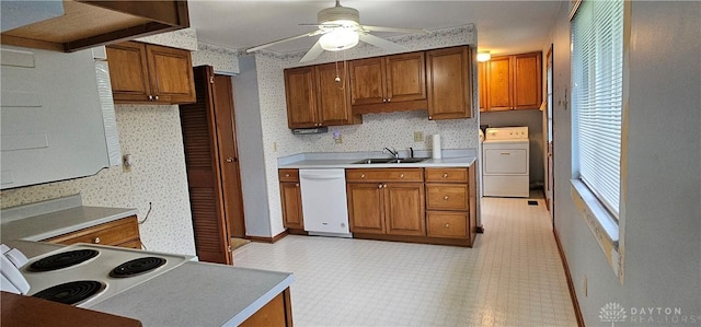 kitchen featuring washer / clothes dryer, white appliances, and brown cabinets