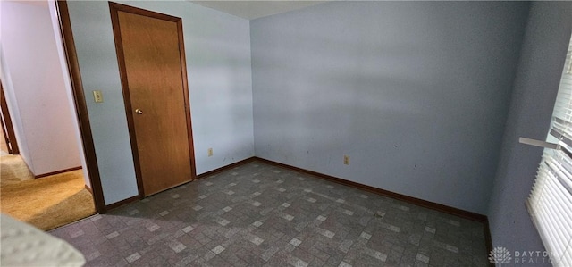 empty room with baseboards