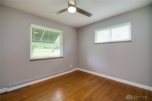 8188 Inwood Ave, Dayton, OH 45415 - spare room featuring a baseboard radiator, plenty of natural light, wood-type flooring, and baseboards