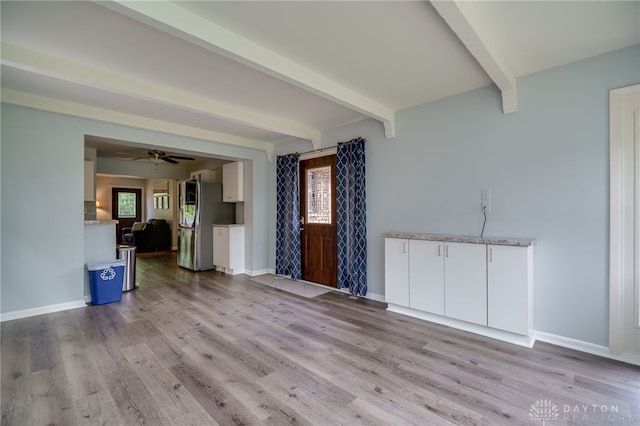 8188 Inwood Ave, Dayton, OH 45415 - unfurnished living room with beamed ceiling, light wood-style floors, baseboards, and a ceiling fan