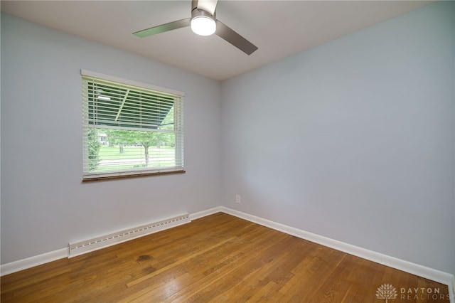 8188 Inwood Ave, Dayton, OH 45415 - spare room featuring a baseboard heating unit, wood finished floors, baseboards, and a ceiling fan