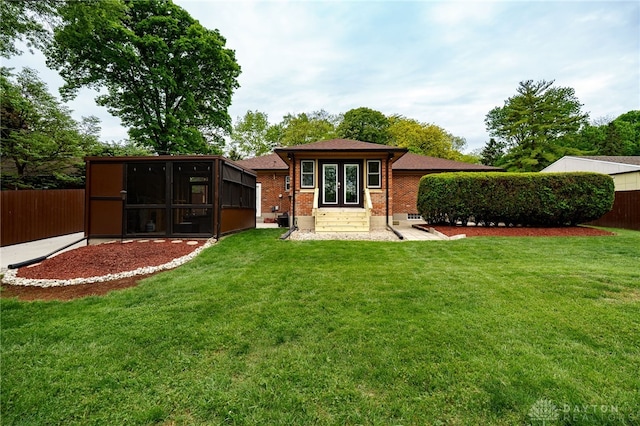 8188 Inwood Ave, Dayton, OH 45415 - back of property featuring french doors, a sunroom, and brick siding