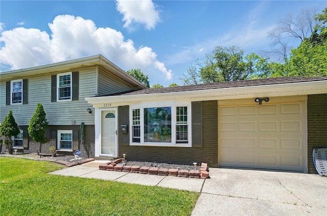 2234 Rubicon Pl, Forest Park, OH 45240 - tri-level home with a garage, brick siding, concrete driveway, and a front yard