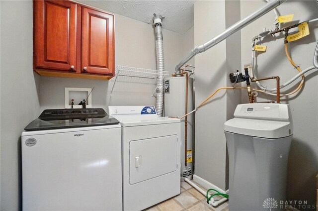 3128 Alexander Pl Unit 206, Beavercreek, OH 45431 - laundry area with cabinet space, water heater, independent washer and dryer, baseboards, and a textured ceiling