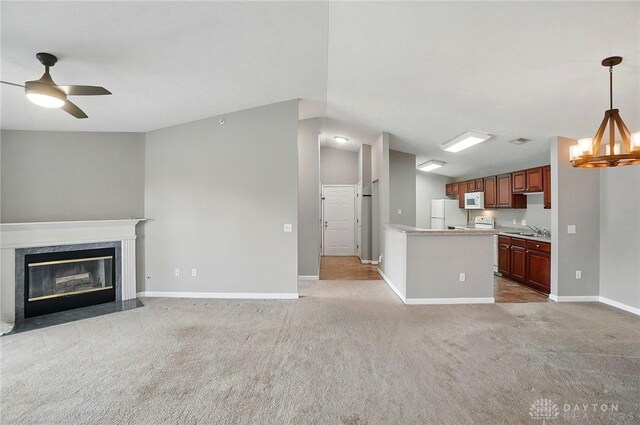 3128 Alexander Pl Unit 206, Beavercreek, OH 45431 - unfurnished living room with a sink, baseboards, carpet flooring, lofted ceiling, and a premium fireplace