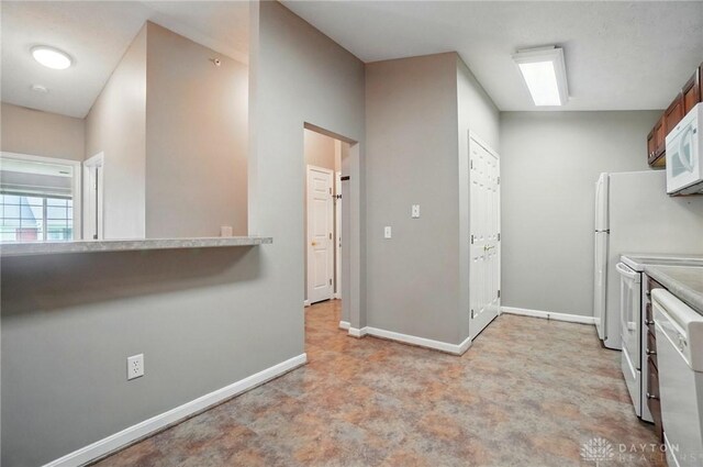 3128 Alexander Pl Unit 206, Beavercreek, OH 45431 - kitchen featuring white appliances, baseboards, and light countertops