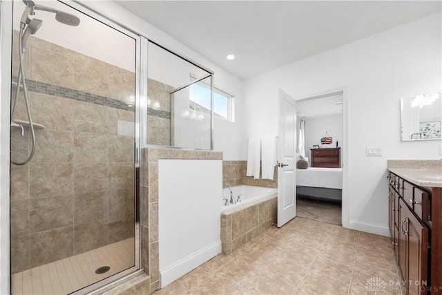 ensuite bathroom featuring a shower stall, vanity, tile patterned flooring, a bath, and baseboards