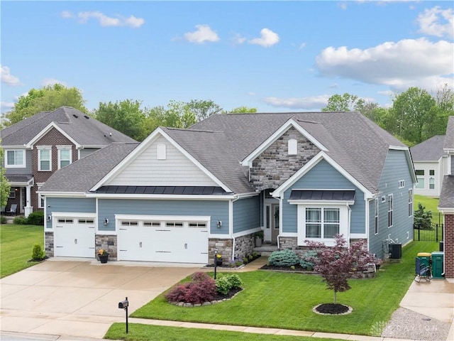 craftsman-style house featuring stone siding, a garage, a standing seam roof, concrete driveway, and a front yard
