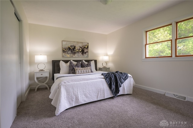 carpeted bedroom featuring baseboards