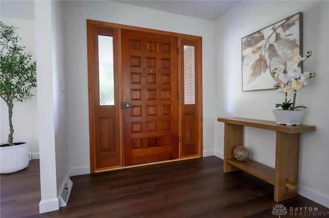 entrance foyer featuring dark wood-style flooring and baseboards