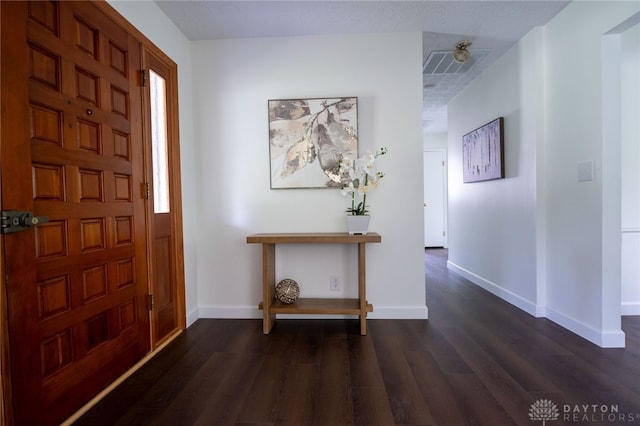 entrance foyer with dark wood finished floors and baseboards
